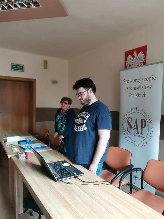 Prelegent Krzysztof Kurowski, obok niego prezes Julia Dziwoki, za nimi baner SAP.